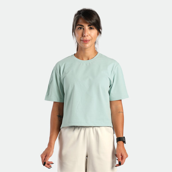 a fit woman wearing t-shirt cloud blue with short  beige 