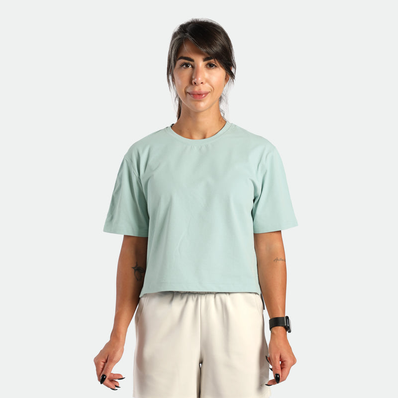 a fit woman wearing t-shirt cloud blue with short  beige 