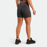 Person wearing black athletic shorts on a white background