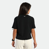 Person wearing a black t-shirt with a logo on the back against a white background