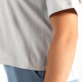 Close-up of a person wearing a light gray shirt with 'Air Force' branding.