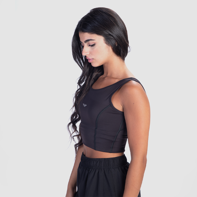 a fit woman stand at right  wearing crop top black with short black