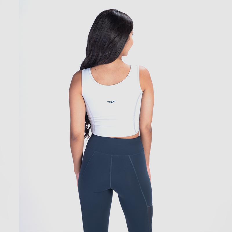  a back view for fit woman wearing  crop top white with logo and legging blue 