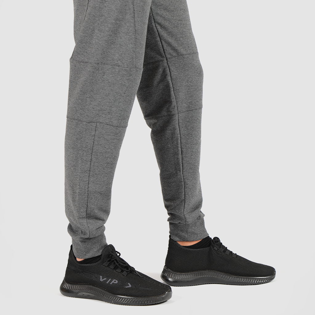 a fit man wearing pants marl light grey with shoes black 