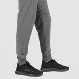 a fit man wearing pants marl light grey with shoes black 