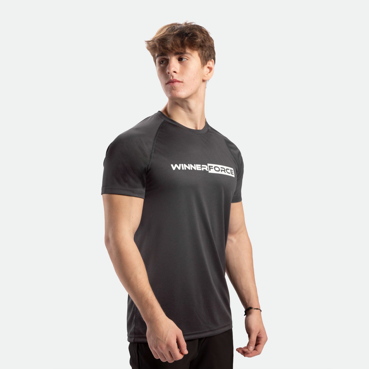 a fit man stand at right and wearing t-shirt dark grey with pants black 