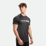 a fit man stand at right and wearing t-shirt dark grey with pants black 