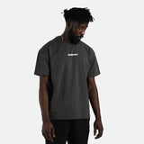 a fit  man wearing t-shirt dark grey with logo ,plus short black 