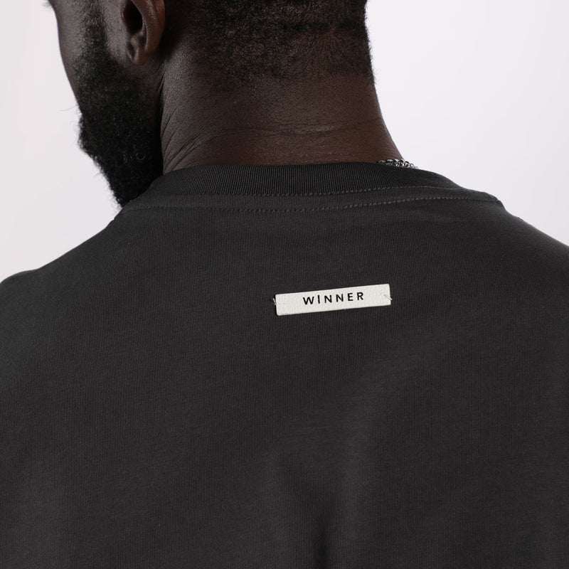 close up view for fit man wearing t-shirt dark grey  with logo