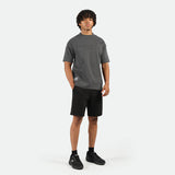 a fit man wearing t-shirt dark grey with short black ,plus he wearing shoes black 