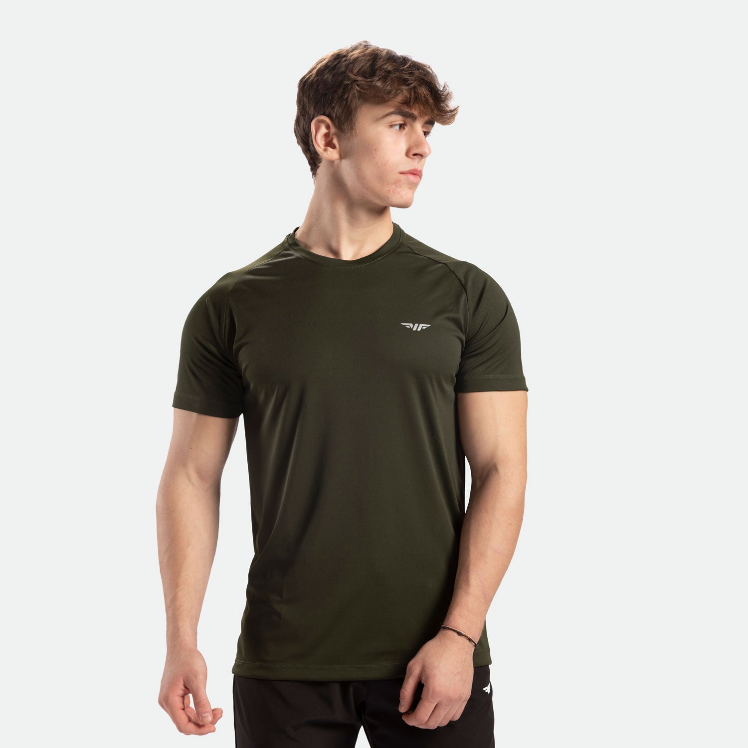 a fit man stand at right and wearing t-shirt dark olive with pants black 