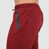 a fit man stand at right and wearing pants dark red with pocket and logo 