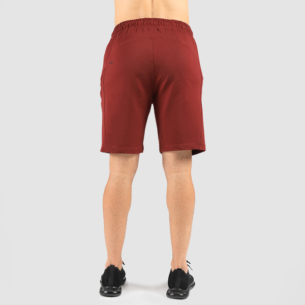 a back view for man wearing short drake red  with shoes black 