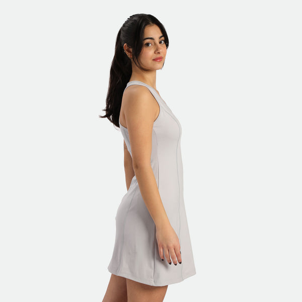 a fit woman stand at right and wearing  dress grey 
