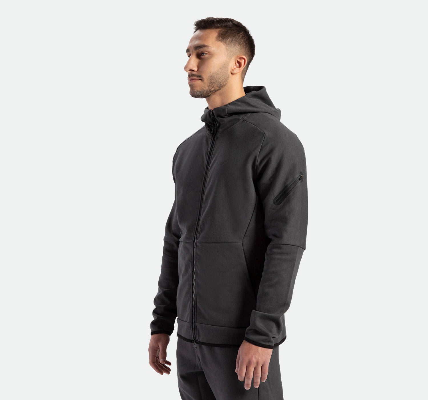 a fit man wearing matching set ebony grey ,tech zipped hoodie with pants 