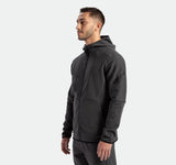 a fit man wearing matching set ebony grey ,tech zipped hoodie with pants 