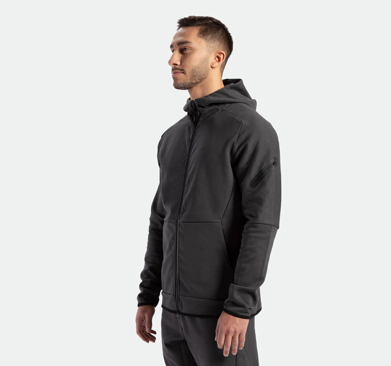 a fit man wearing matching set ebony grey ,tech zipped hoodie with pants 