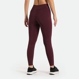  a back view for woman wearing  legging red  and shoes black ,plus background light grey