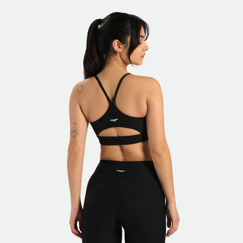 a women wearing bras and leggings ,have same logo ,plus the bras have a special design