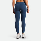 a back view for fit woman wearing legging  ensign blue with shoes white 
