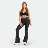 a fit man wearing bras sports black with flared legging  graphite grey leopard  with shoes 