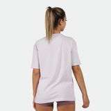 a back view for fit woman wearing t-shirt lavender blue with short 