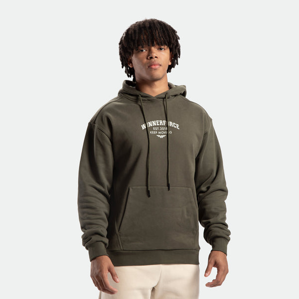 A male model wearing a green hoodie with a hood and an adjustable drawcord. The hoodie features a graphic on the front and the name 'Beyond The Origin' on the sleeve.