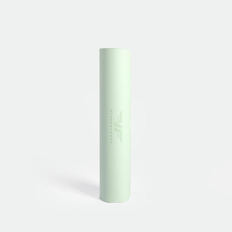 A light green cylindrical yoga mat stands vertically against a white background. The brand logo and name "Winnerforce" are subtly printed on the surface.