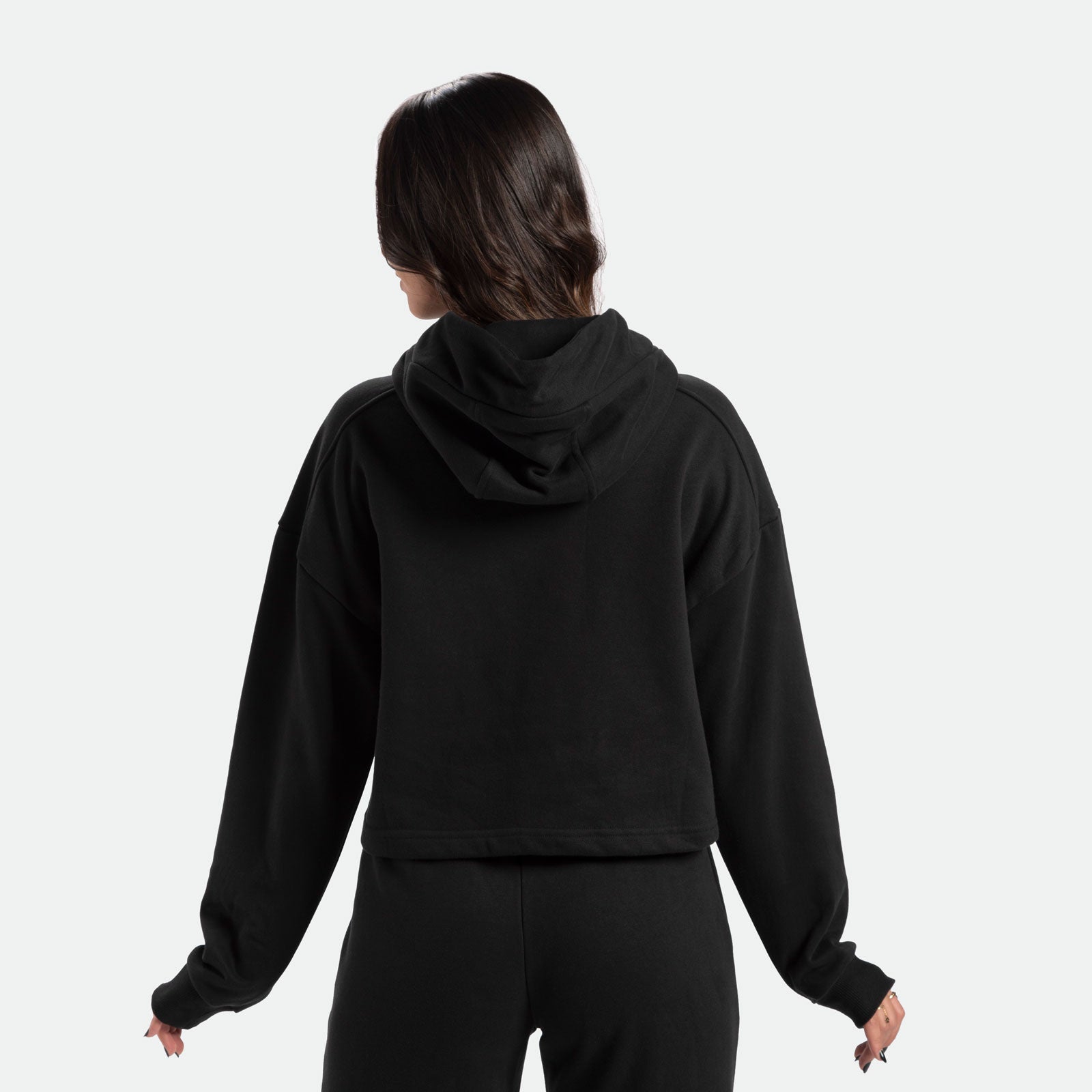 a back view for fit woman  wearing  matching set  black hoodie and  pants 