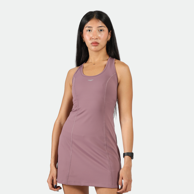 a fit woman look at the camera with confidence ,she wearing dress purple 