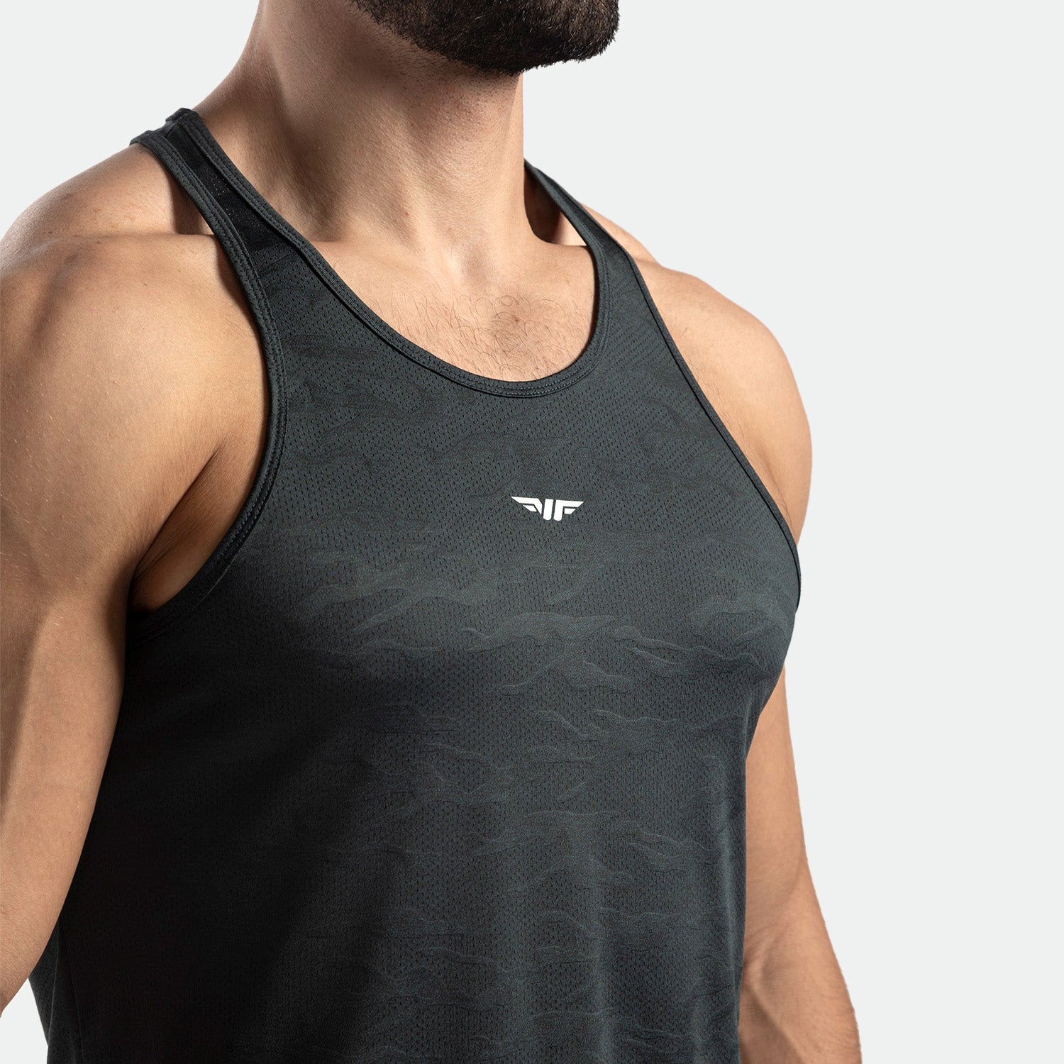 close up view for fit man wearing tank  graphite grey with logo in half 