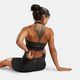 a back view for woman sides on it and wearing matching set graphite grey , bra and short 