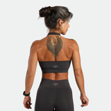 a back view for fit woman wearing matching set graphite grey ,bra and legging plus the logo