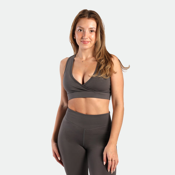a fit woman wearing matching set quite shade grey ,bra and legging 