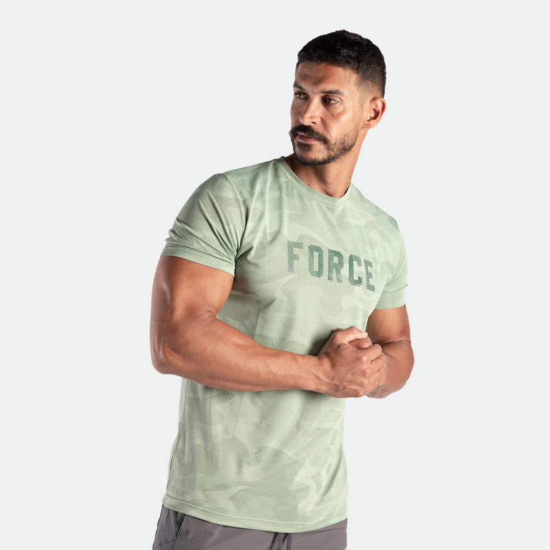 a fit man wearing t-shirt camo green bay with logo and pants grey 