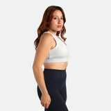a fit woman stand at right and wearing bra grey with legging black 