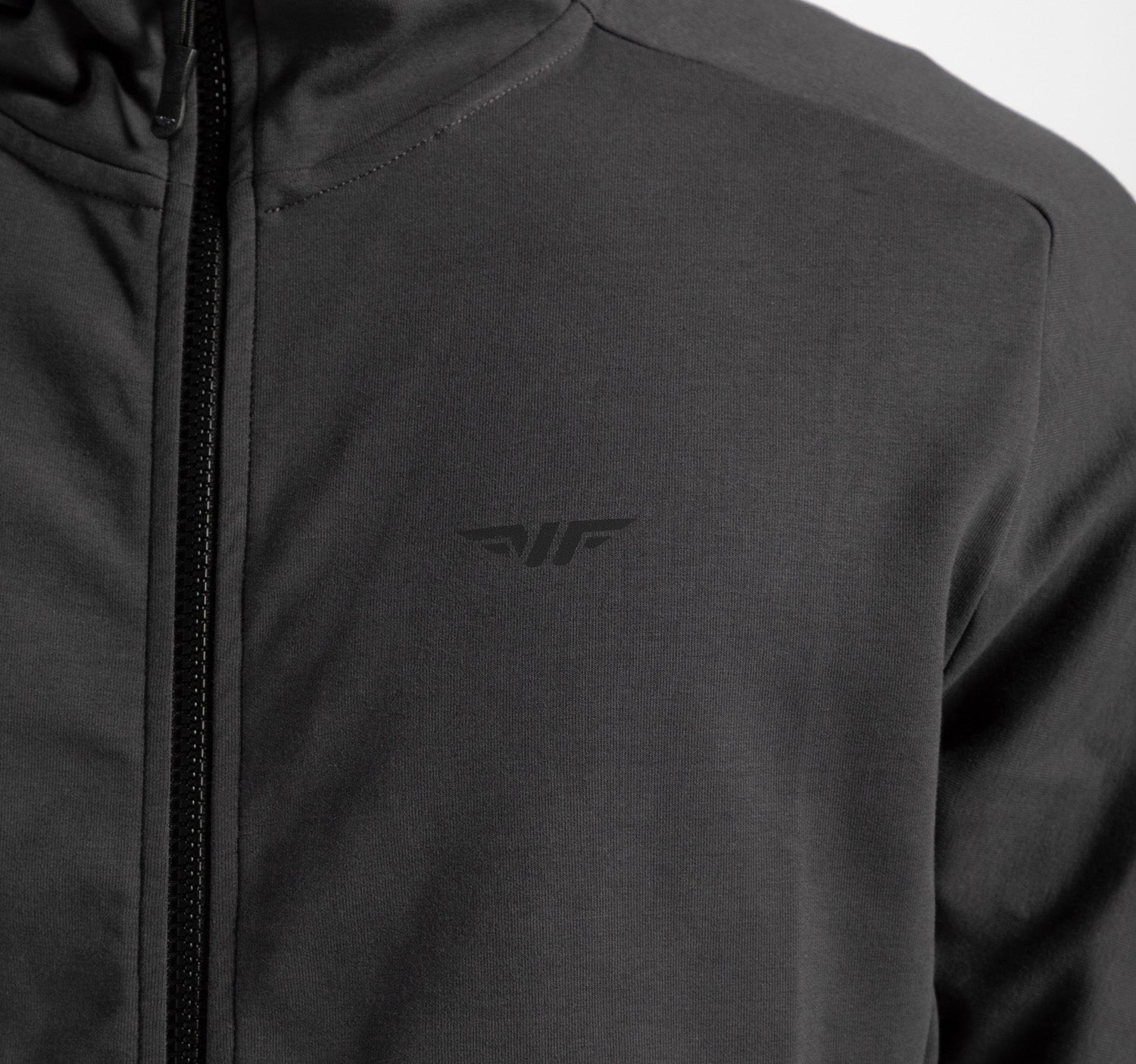 close up view for fit man wearing tech zipped hoodie ebony grey with logo 