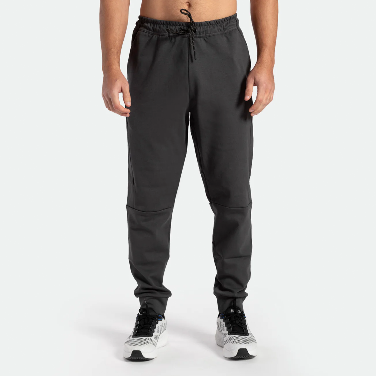 a fit man wearing pants grey ebony with shoes sports 