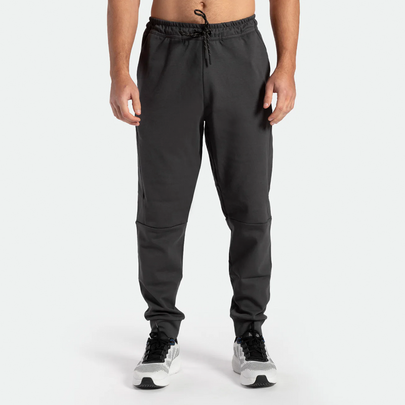 a fit man wearing pants grey ebony with shoes sports 