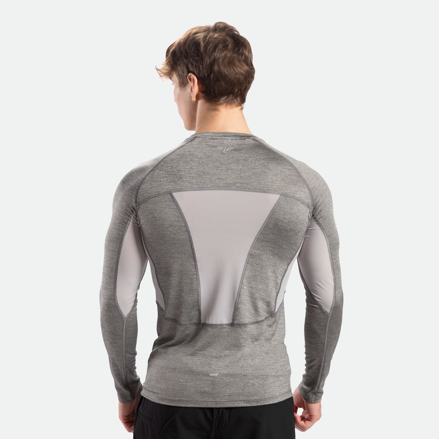 a back view for fit man wearing sleeve t-shirt  grey  with pants black 