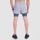 a back view for fit man wearing short grey 2 in 1 with shoes black 