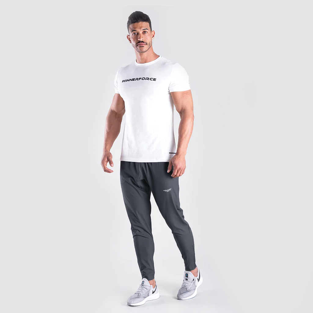 a fit man wearing t-shirt white with logo and he wearing  pants grey  with logo ,plus  the shoes 