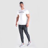 a fit man wearing t-shirt white with logo and he wearing  pants grey  with logo ,plus  the shoes 
