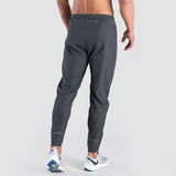 a back view for fit man wearing pants grey with shoes ,plus he wearing shoes 