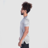 a fit man stand at right and wearing t-shirt grey with short black  