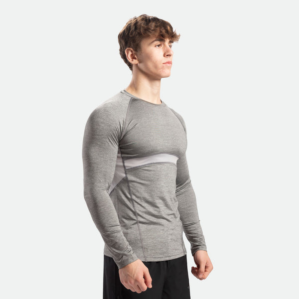a fit man stand at right and wearing sleeve t-shirt grey with pants black 