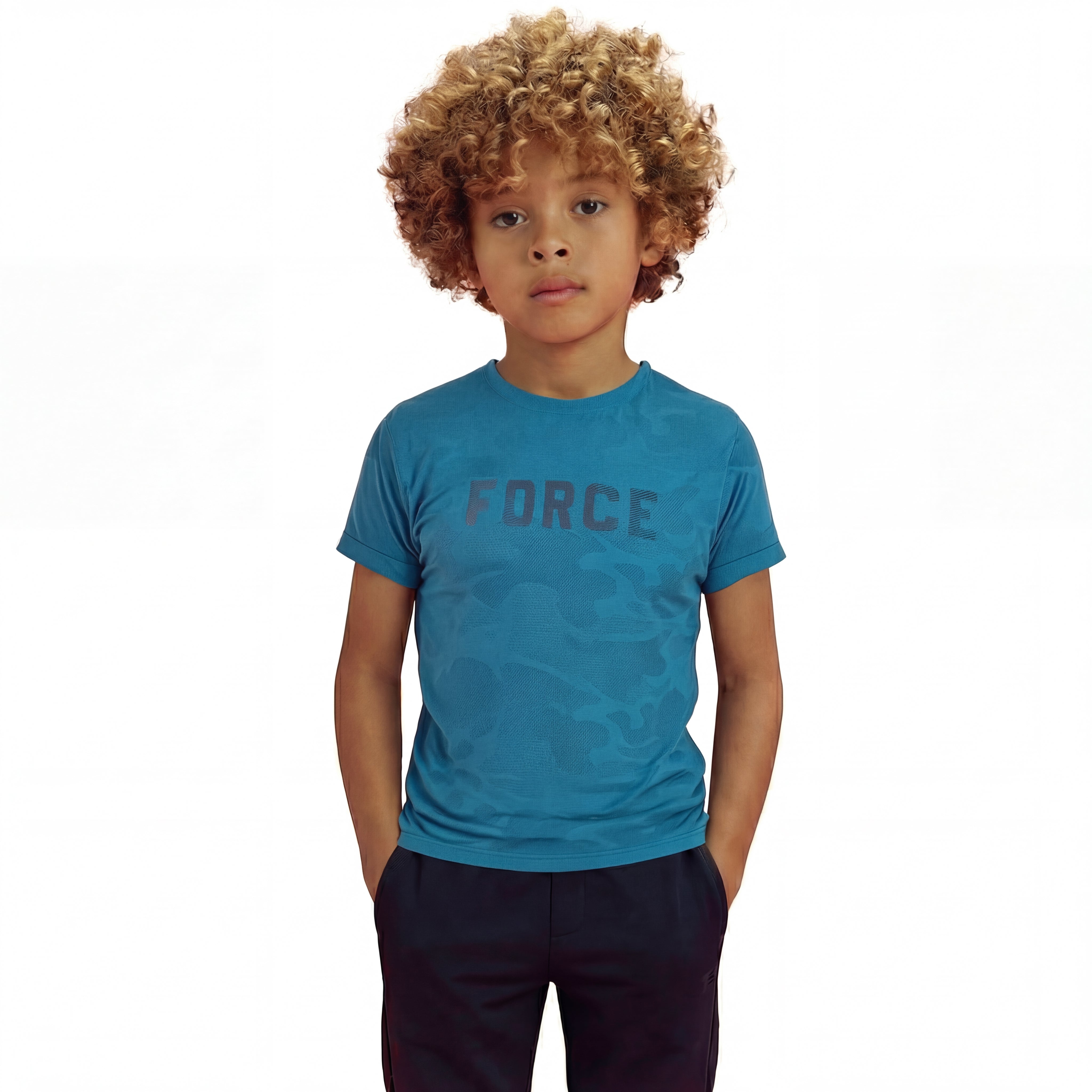 A boy posing and wearing a regular fit saxony blue camo t-shirt with the word FORCE in big on it. He is also wearing navy pants.