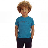 A boy posing and wearing a regular fit saxony blue camo t-shirt with the word FORCE in big on it. He is also wearing navy pants.