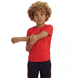 A boy posing and wearing a regular fit camo t-shirt in the color high risk red. He is also wearing navy pants.