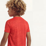Back view close-up of a boy wearing a regular fit camo t-shirt in the color high risk red.